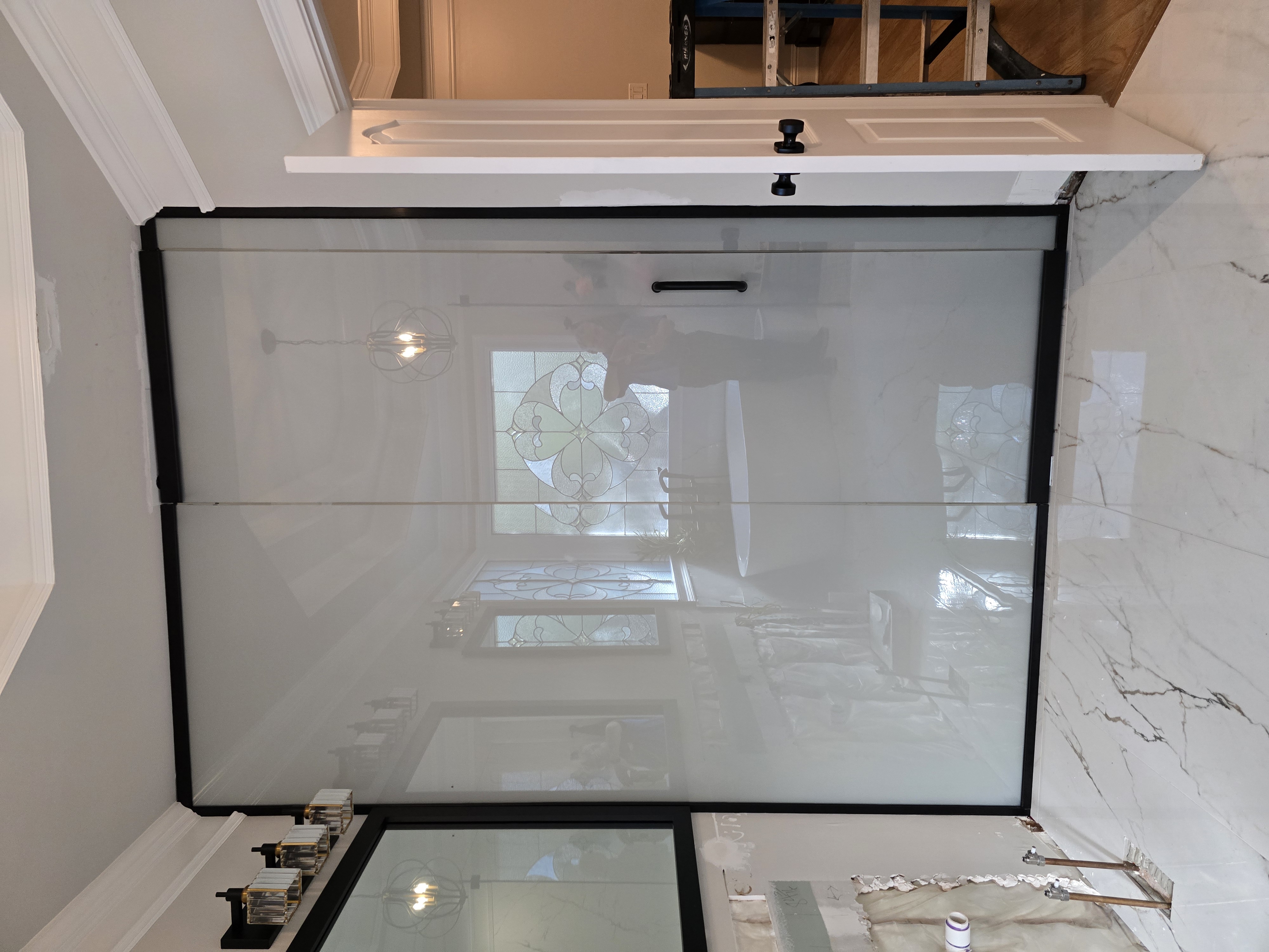 This project was a collaboration with Harry's Home Renovations (https://www.harryshomerenovations.com/) and M3 Glass Technologies (https://www.m3glass.com/switchable-glass). The glass is SwitchLite® smart glass, which transitions from clear to frosted at the touch of a button — combining privacy and sophistication in one sleek solution.