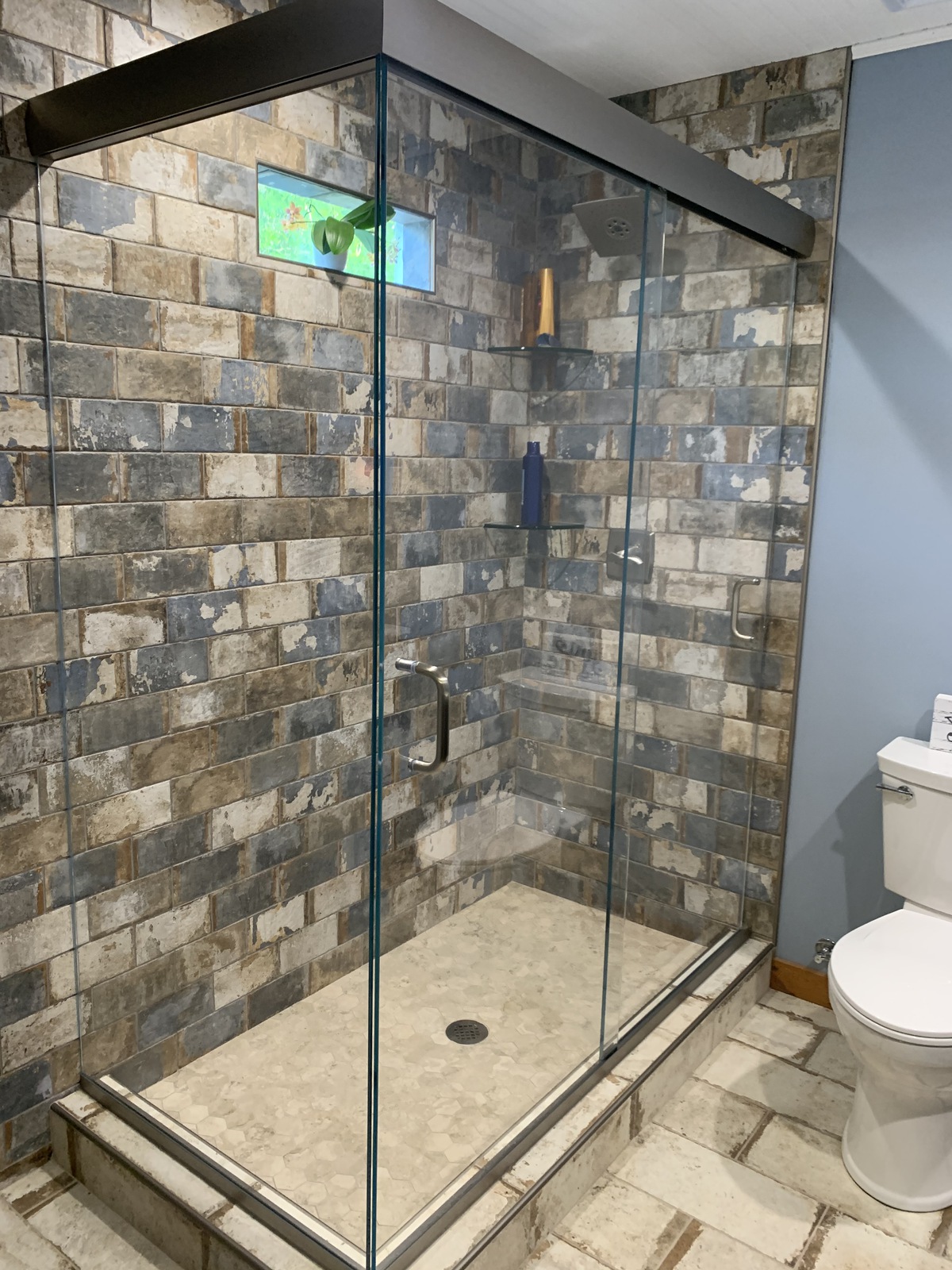 One of the only sliders of its kind, this Cottage series sliding system allows the doors to bypass and also supports a third, fixed panel. Believe it or not, this system is finished in brushed nickel, however, the lighting makes the system appear more brown.